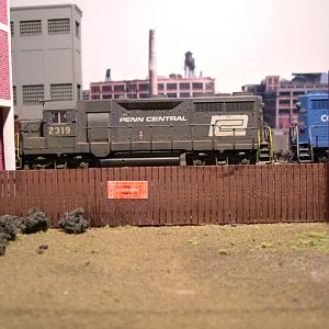Weathered GP-35s pulling cut of cars down track 1